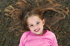 Girl laying in grass.